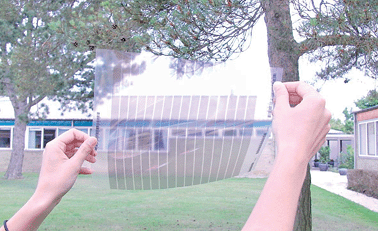 Photograph showing a view through indium-free thin silver based semitransparent front electrode prepared by slot-die coating, using only low temperatures and very little material. This electrode type was explored in this work and presents a sheet resistance < 10 Ω square−1 and an optical transmission of > 50% in the entire visible range of wavelengths.