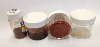 Right to left, comparison of off-white sample of Fe-CAB-O-SIL® 1 : 4 (Fe from Fe(NO3)3-nonahydrate), Fe-CAB-O-SIL® 1 : 4 complexed with 1,10-phenanthroline, Fe2O3 over 1,10-phenanthroline under toluene, and powdered Fe2O3.